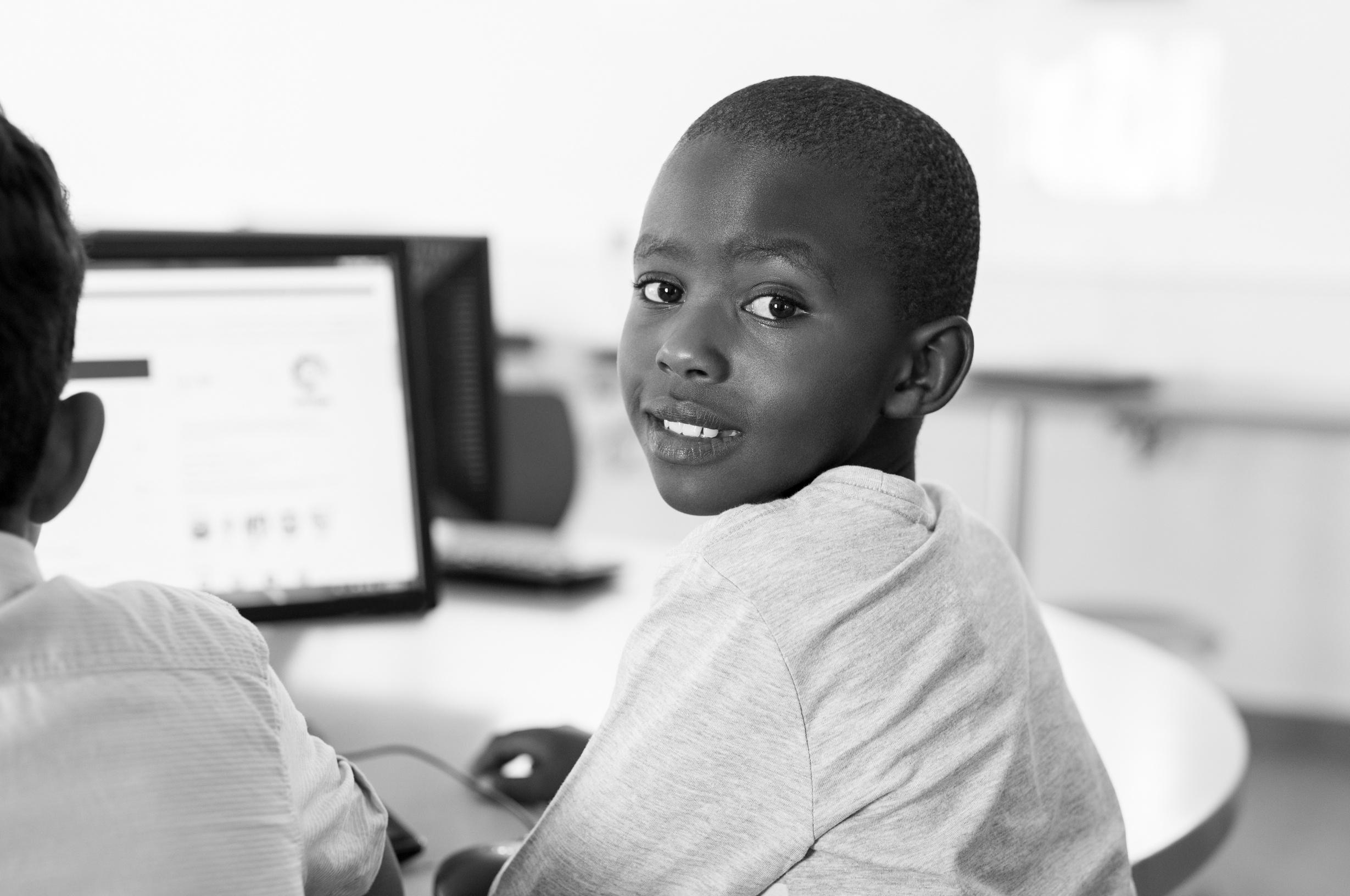Student engaging with computer technology in classroom lab